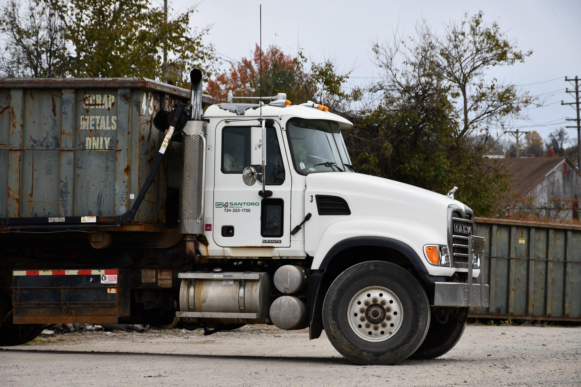 Santoro Metals, Inc. roll-off truck hauling a scrap container at the Washington yard